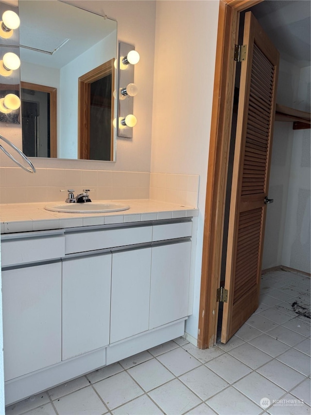 bathroom with vanity, tasteful backsplash, and tile patterned floors