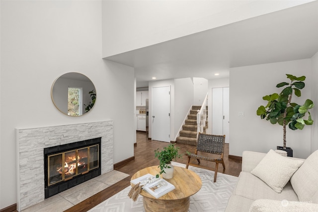 living room with a fireplace and light wood-type flooring