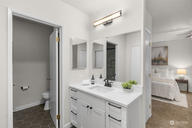 bathroom featuring tile patterned floors, vanity, and toilet