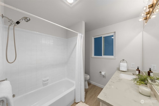 full bathroom featuring vanity, hardwood / wood-style floors, shower / bath combo with shower curtain, and toilet