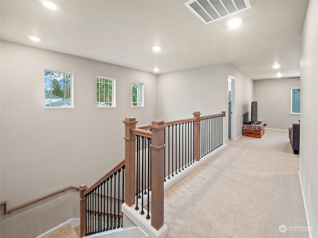 corridor featuring light colored carpet