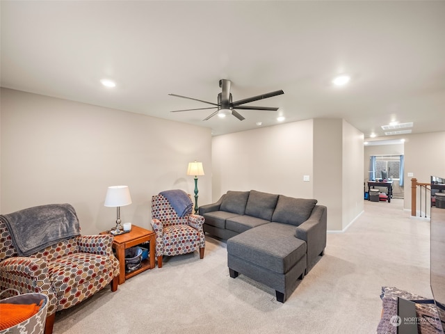 carpeted living room featuring ceiling fan