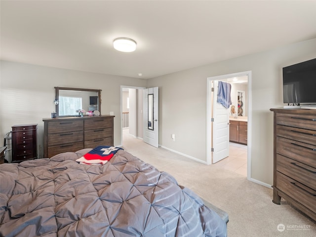 carpeted bedroom featuring ensuite bathroom