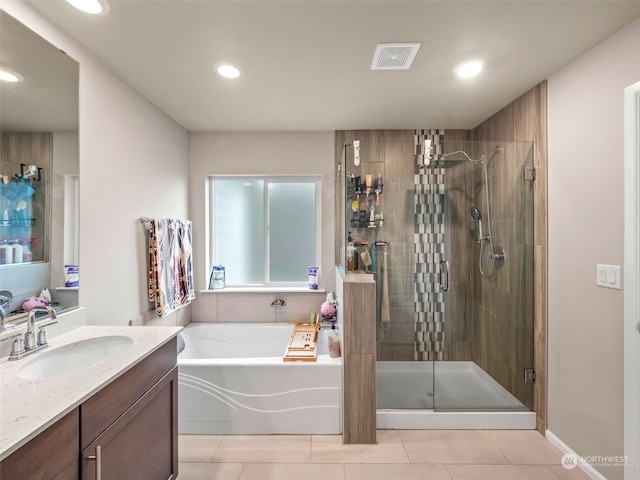 bathroom with independent shower and bath, vanity, and tile patterned flooring