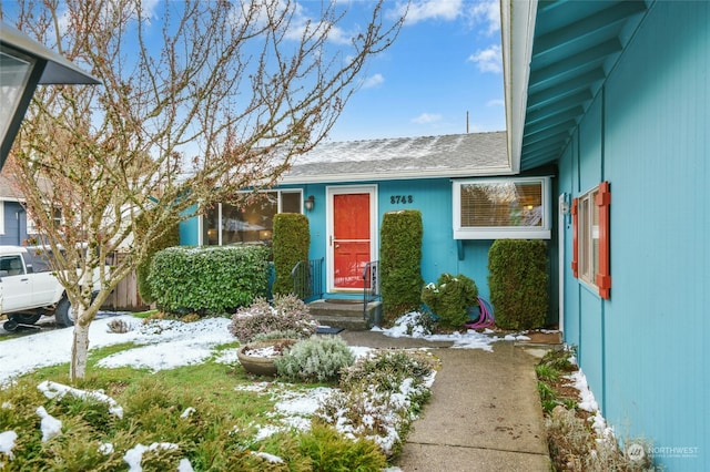 view of snow covered property entrance