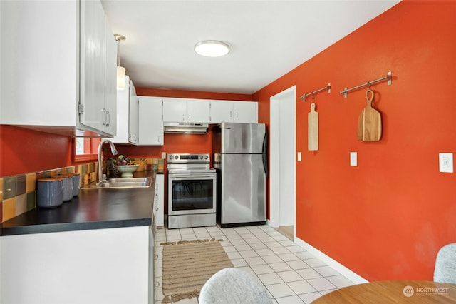 kitchen with pendant lighting, sink, light tile patterned floors, appliances with stainless steel finishes, and white cabinets