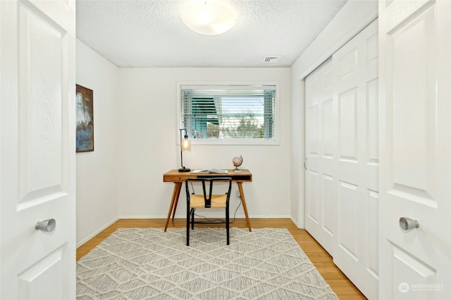 interior space with hardwood / wood-style floors and a textured ceiling