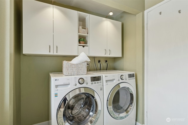 laundry room with cabinets and washing machine and dryer