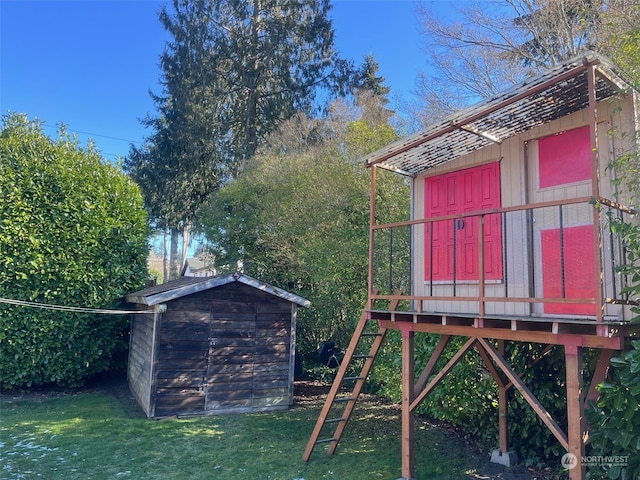 view of play area featuring a storage shed and a lawn