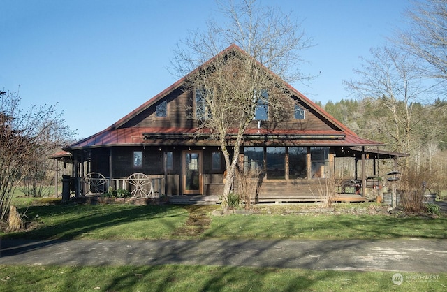 back of property with a porch and a lawn