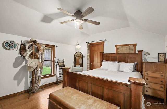 bedroom with ceiling fan, vaulted ceiling, and light hardwood / wood-style flooring