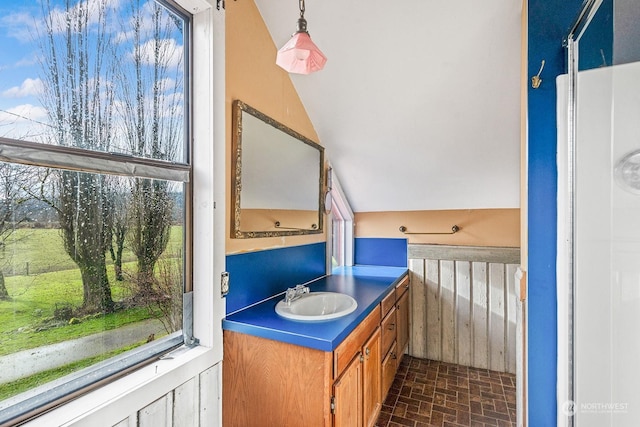 bathroom featuring lofted ceiling and vanity