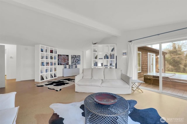 living area with lofted ceiling with beams