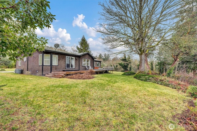 exterior space featuring a deck, central AC, and a front yard