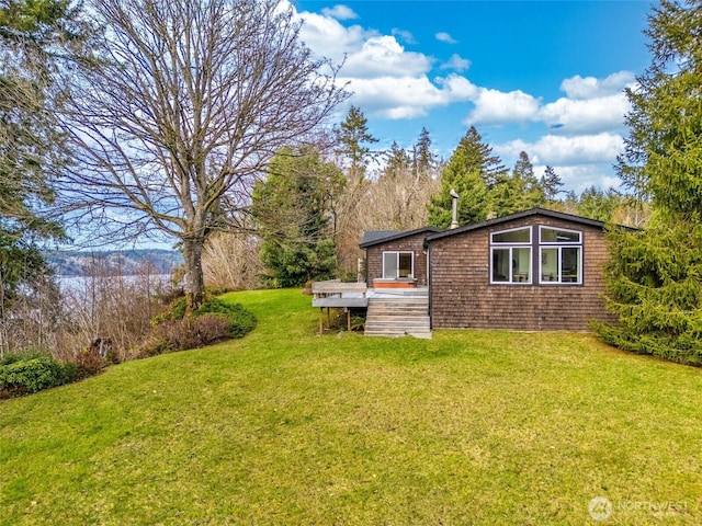 view of property exterior featuring a lawn and a wooden deck