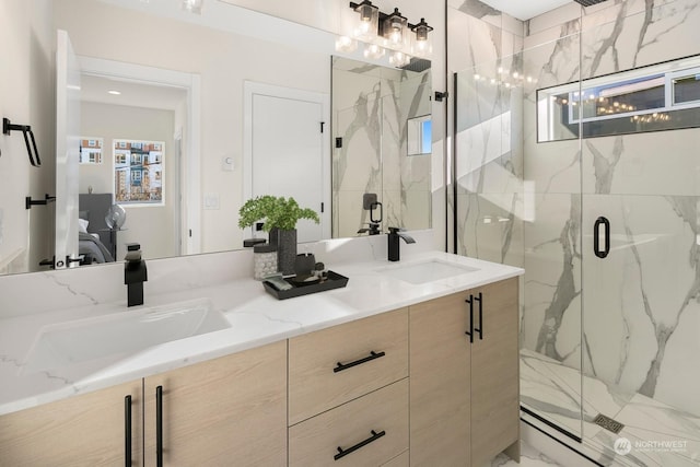 bathroom with vanity, a wealth of natural light, and a shower with door