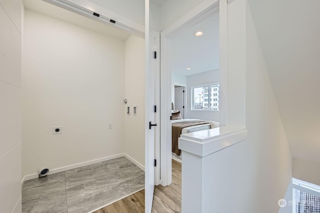 washroom featuring light hardwood / wood-style floors and electric dryer hookup