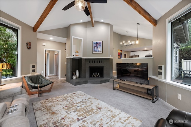 living room with beam ceiling, a fireplace, light colored carpet, and a healthy amount of sunlight