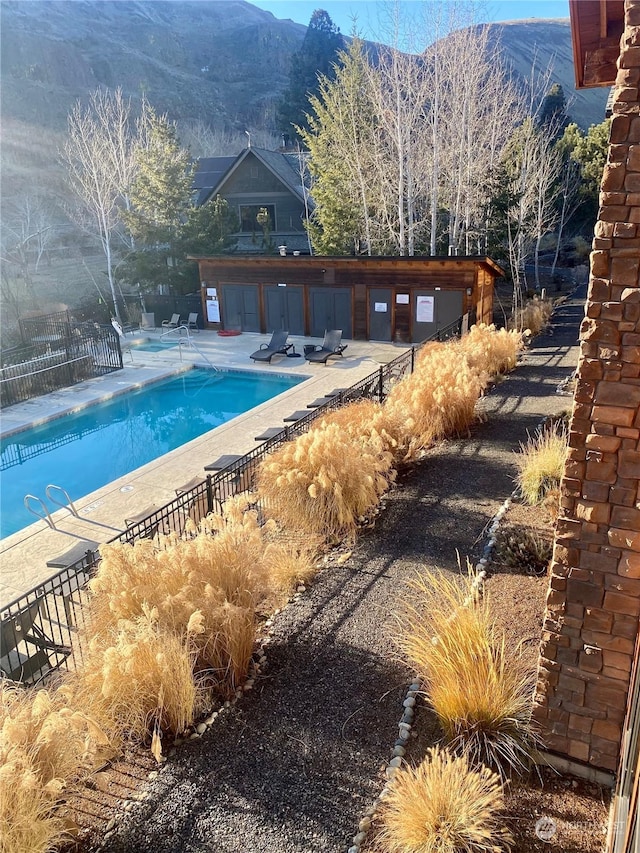 view of swimming pool featuring a patio and a mountain view