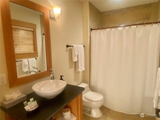 bathroom with vanity, curtained shower, tile patterned floors, and toilet