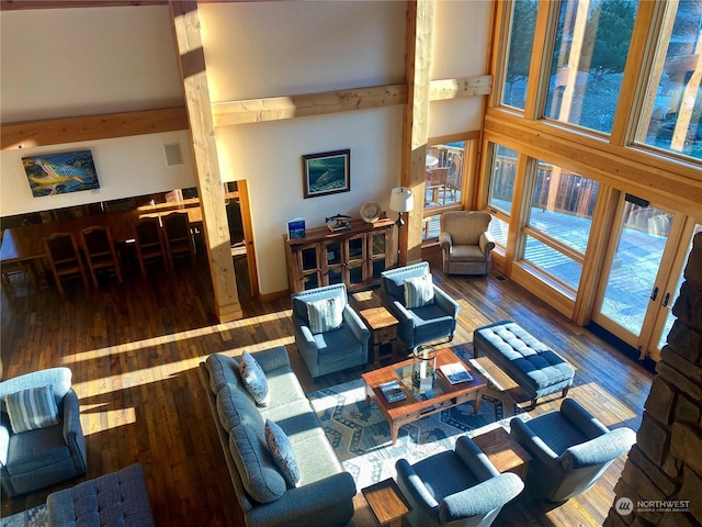 living room with dark hardwood / wood-style flooring and a towering ceiling