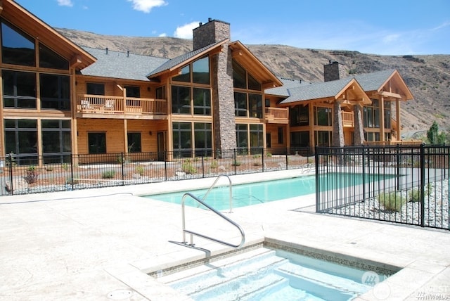 view of swimming pool with a mountain view and a patio