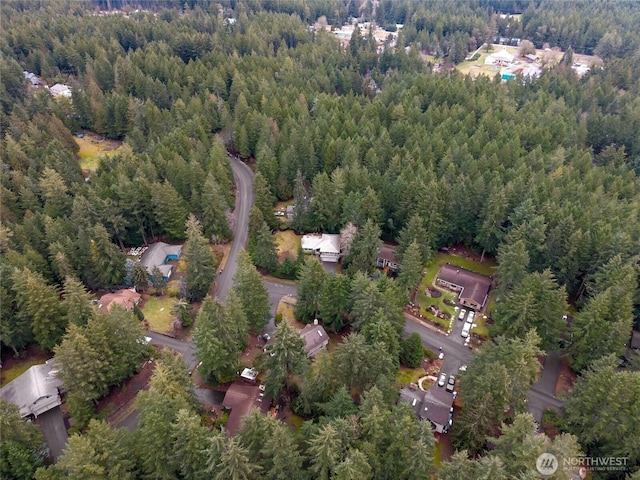 drone / aerial view featuring a wooded view