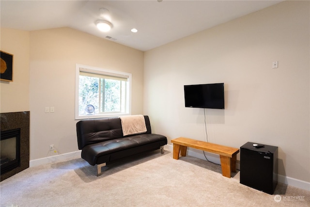 carpeted living room featuring vaulted ceiling