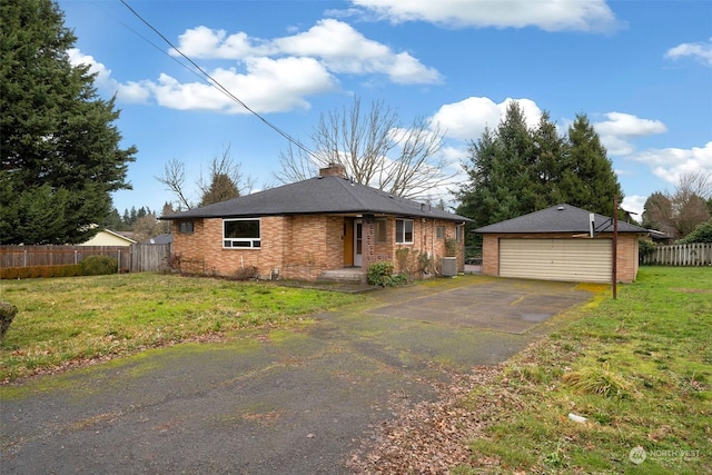 exterior space with a garage, a yard, an outbuilding, and central AC unit