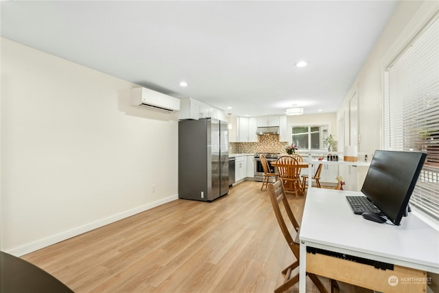 office space featuring a wall unit AC and light wood-type flooring