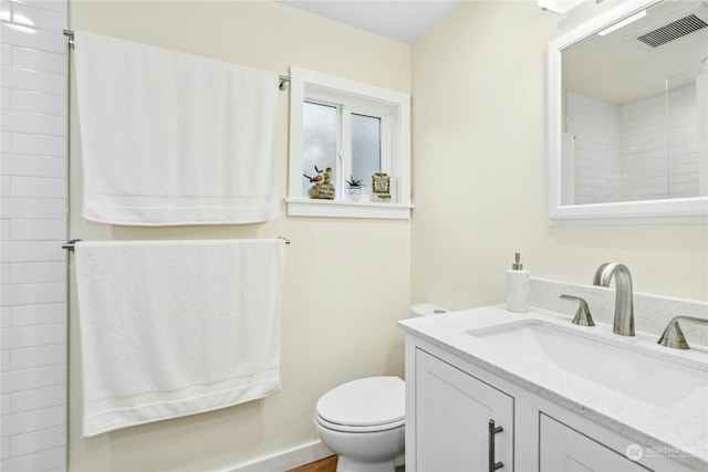 bathroom with vanity and toilet