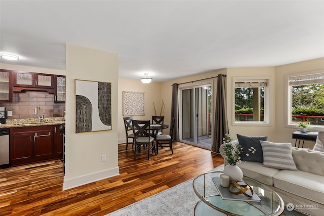 living room with dark hardwood / wood-style flooring and sink