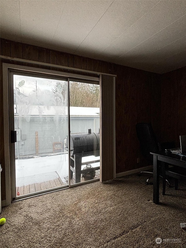 interior space with carpet and wooden walls