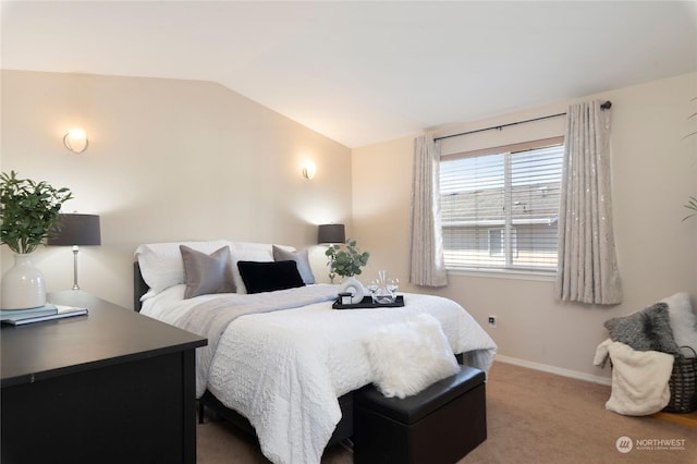 carpeted bedroom with lofted ceiling