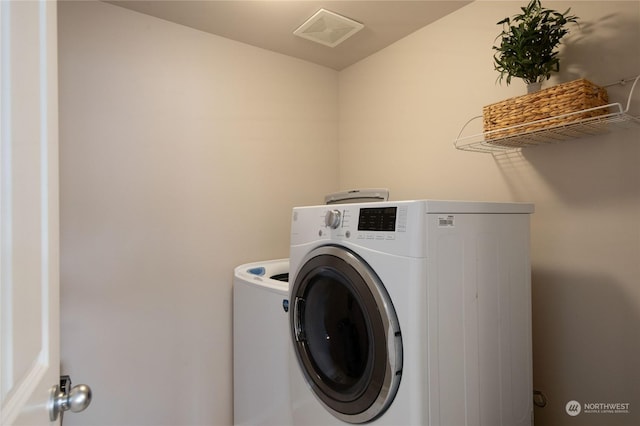 washroom featuring independent washer and dryer