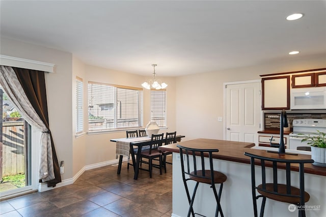 tiled dining space featuring a notable chandelier