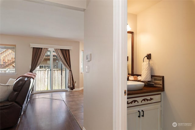 corridor with hardwood / wood-style flooring