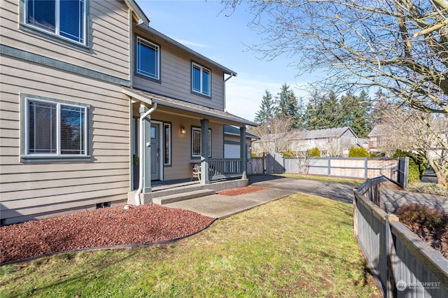 exterior space featuring a yard and covered porch