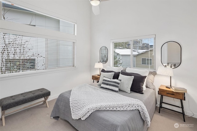 bedroom featuring light carpet and ceiling fan