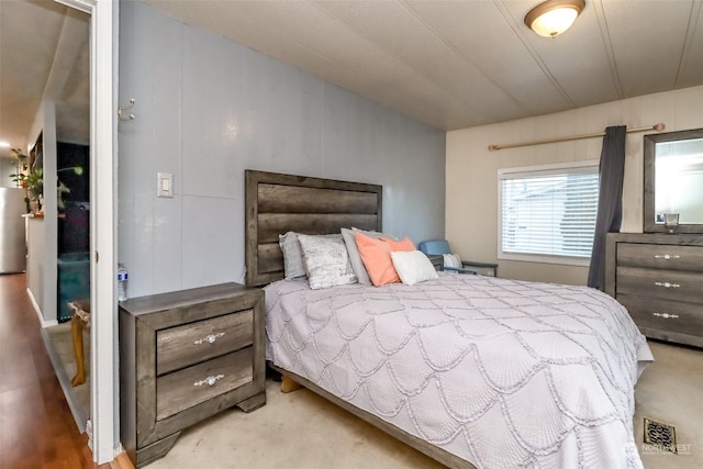 bedroom featuring stainless steel fridge