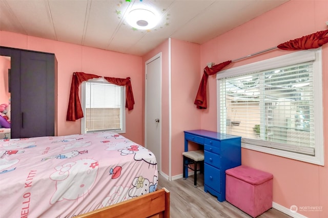 bedroom featuring light hardwood / wood-style floors and a closet