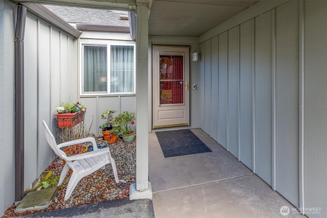 view of exterior entry featuring board and batten siding