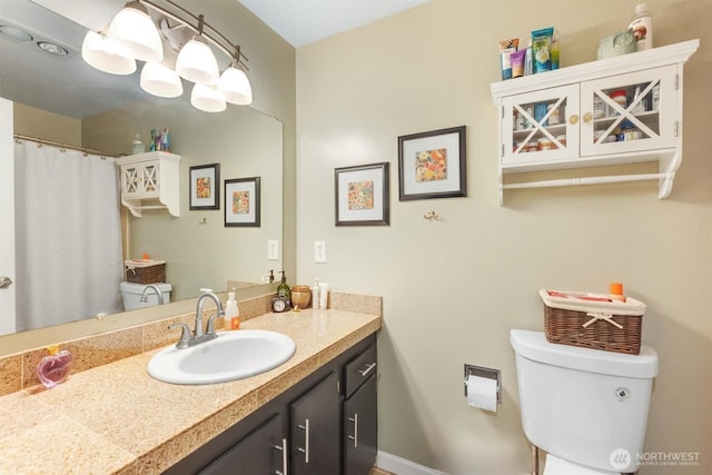 full bathroom with toilet and vanity