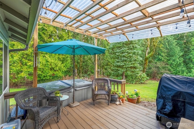 deck featuring grilling area, a hot tub, and a yard