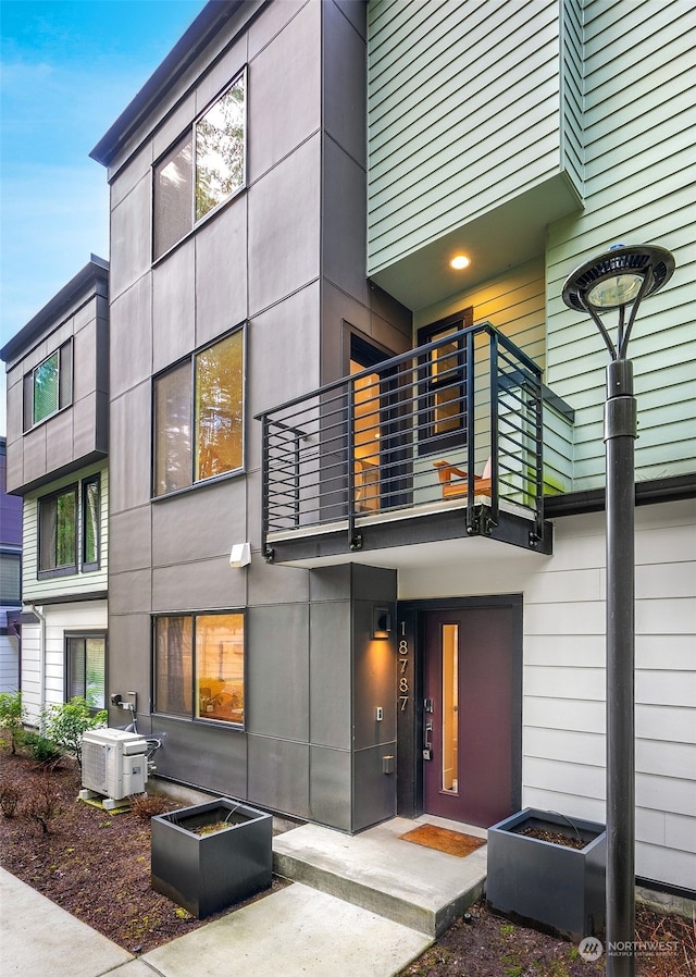 rear view of house featuring central AC unit