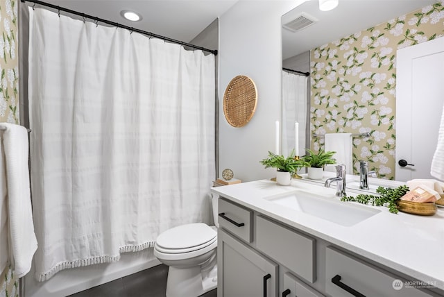 bathroom featuring vanity and toilet