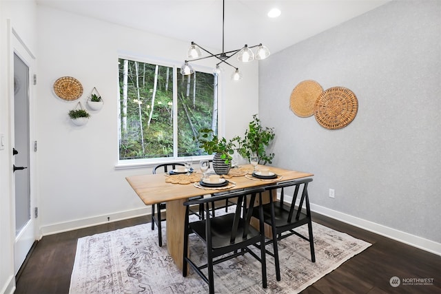 dining area featuring dark hardwood / wood-style floors and a chandelier