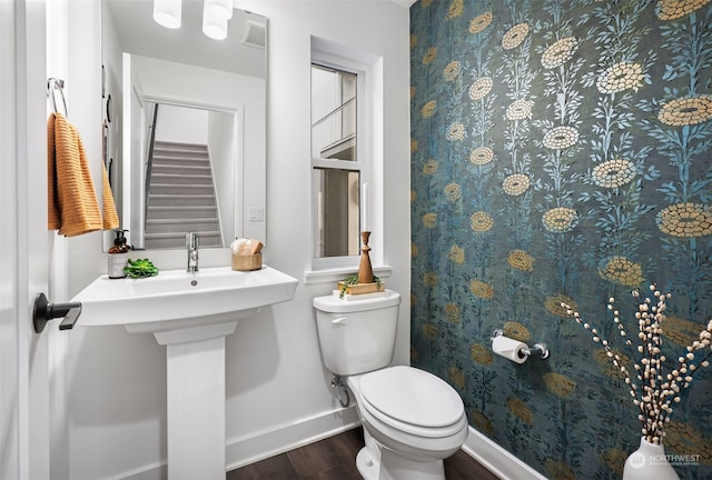 bathroom featuring hardwood / wood-style flooring and toilet