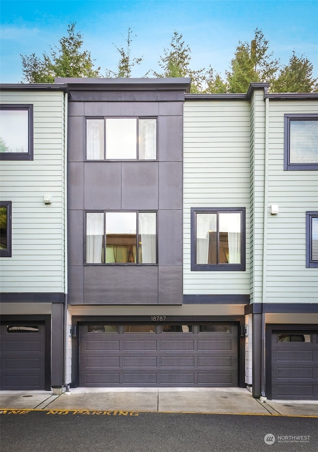 rear view of house featuring a garage