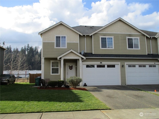 view of front of house featuring a garage and a front lawn